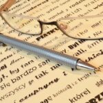 writing with pen and glasses