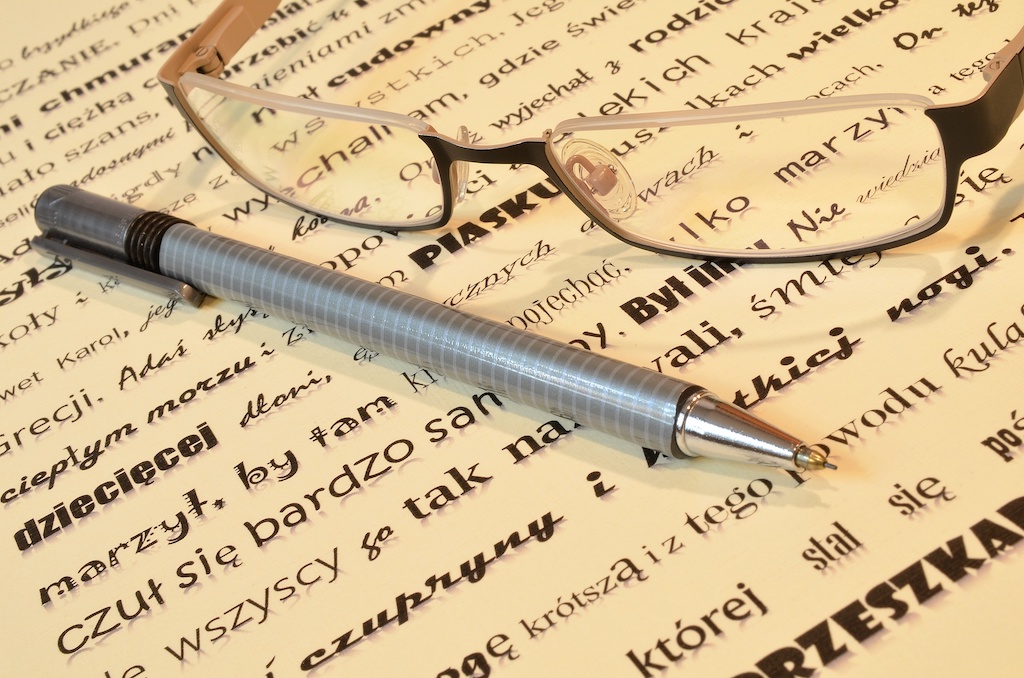 writing with pen and glasses